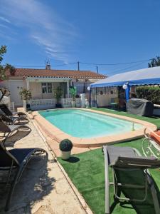 a swimming pool in the yard of a house at VILLA Soleil et Douceur in La Seyne-sur-Mer