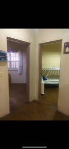 an empty room with a bed and a window at Chalé aconchegante em São Roque in São Roque +11 photos