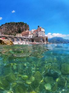a view of the water in front of a castle at Francesca House in Atrani