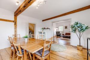a dining room and living room with a wooden table and chairs at Am Weissen Turm in Kulmbach