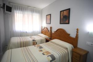 Postel nebo postele na pokoji v ubytování Hostal Santa Barbara