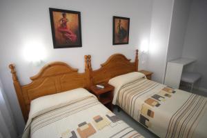 Postel nebo postele na pokoji v ubytování Hostal Santa Barbara