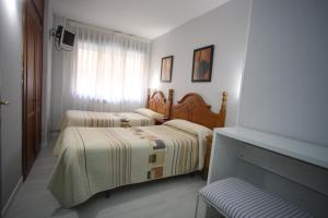 Postel nebo postele na pokoji v ubytování Hostal Santa Barbara