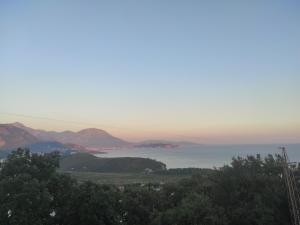 a view of the ocean with mountains in the distance at Apartman PETRA Green Hill in Sutomore +2 photos