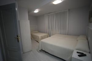 Postel nebo postele na pokoji v ubytování Hostal Santa Barbara