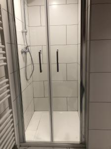 a shower with a glass door in a bathroom at Chalet Leslie in Morzine