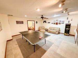 a living room with a ping pong table in it at Spacious Arcade Table Tennis Game Room Cowboy Pool Near Tx Motor Speedwayby Vacation Your Way in Fort Worth