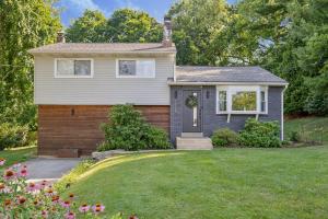a house with a lawn in front of it at Modern Mid-Century Retreat in West Chester