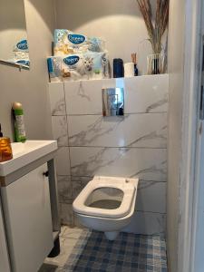 a bathroom with a white toilet and a sink at Radiant BD Wejscie na kod in Gdynia +24 photos