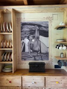a painting of two mermaids on a wall in a kitchen at Alice Chalet Bled - Adults only in Bled