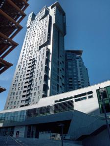 a tall building with a train in front of it at Radiant BD Wejscie na kod in Gdynia +21 photos
