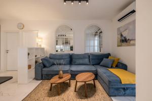 a living room with a blue couch and a table at Apt with best rated breakfast ZAP B&B in Split