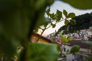 a view of a city from behind some leaves at Amalfi Luxury House in Amalfi