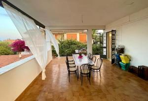 a dining room with a table and some chairs at LAPILLI Holidays in San Giovanni la Punta