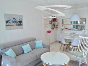 a living room with a couch and a table at Le Copacabana Riviera in Nice