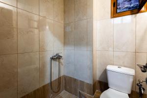 a bathroom with a shower and a toilet at Στούντιο Στη Στοά Βαρβουτσή#9 in Kalamata