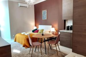 a bedroom with a bed and a table and chairs at Luxury Apartment - Rakowicka R15 in Krakow