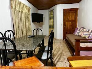 a living room with a table and a couch at DOÑA ROSA in Puerto Iguazú