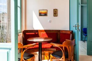 a table and two stools in front of a room at Στούντιο Στη Στοά Βαρβουτσή#10 in Kalamata +12 photos