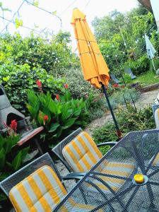 a table and chairs with an umbrella on a patio at Apartment Sea Garden in Ičići