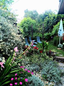 a garden with chairs and flowers in a yard at Apartment Sea Garden in Ičići