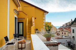 a balcony with a view of a yellow building at Amalfi Luxury House in Amalfi
