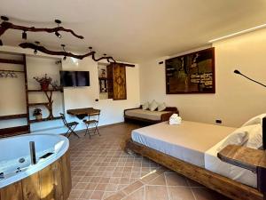 a bedroom with a bed and a bath tub and a room at Villetta Capodimonte in Naples