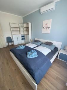 a bedroom with a large bed with towels on it at AZUR Apartments Alsóörs in Alsóörs +94 photos
