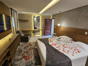 a bedroom with a bed with red flowers on it at Rancho Parati in Martins