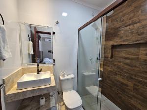 a bathroom with a toilet and a sink and a shower at Rancho Parati in Martins +10 photos