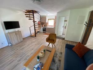 a living room with a blue couch and a table at Deni&Dino in Lohovo