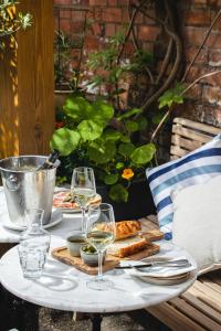 a table with glasses of wine and food on it at Lion & Pheasant Hotel in Shrewsbury