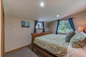 a bedroom with a bed and a window at Moonbeam Condo - Beautiful 2 Bedroom Stay by Beach in Pepin