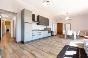 a living room with a kitchen and a dining room at Relis rooms in Quartu SantʼElena