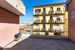 a balcony view of a yellow building with balconies at Relis rooms in Quartu SantʼElena