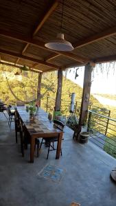 a wooden table in a pavilion with a view of a field at Valle Hermoso Salta in Salta