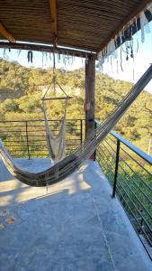 a hammock on a porch with a view of a field at Valle Hermoso Salta in Salta +27 photos