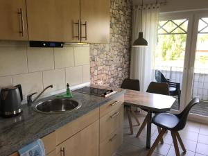 a kitchen with a sink and a table with chairs at Sonnenwind in Prerow