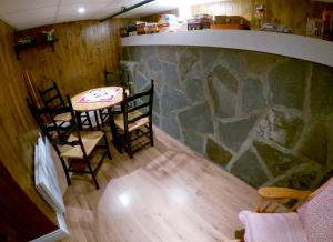 a room with a table and chairs and a stone wall at Chez Caro et Sylvain in Rimouski +14 photos