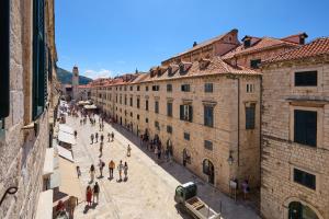 a group of people walking down a street between buildings at TUDISI LUX SUITES by DOMINIUM in Dubrovnik