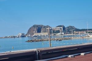 a view of a harbor with rocks in the water at Maisonnette chez l'habitant in La Ciotat