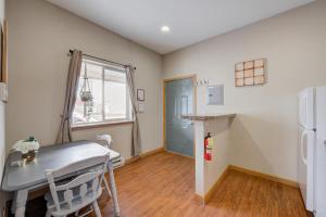a kitchen with a table and a refrigerator at Studio Condo Near Lake Pepin - King Bed - Dewdrop in Pepin