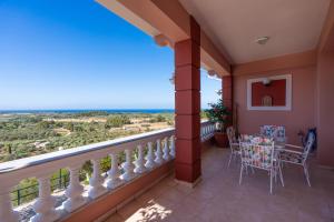 a balcony with a view of the ocean at La Dimora in Lixouri