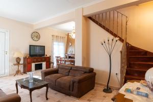 a living room with a couch and a staircase at La Dimora in Lixouri