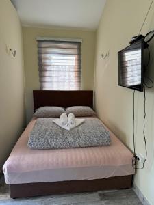 a bedroom with a bed with two shoes on it at Crystal pool in Bihać +19 photos
