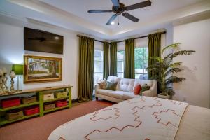 a living room with a bed and a couch at Elegant Baton Rouge Home with Yard about 3 Mi to LSU! in Baton Rouge