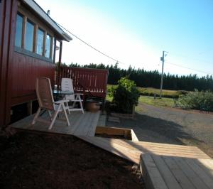 
a person sitting on a bench next to a train at Waterview B&B in Pictou
