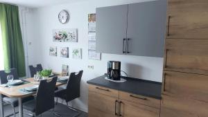 a kitchen with a table with chairs and a counter top at Haus Woschi Kehl-Auenheim in Kehl am Rhein