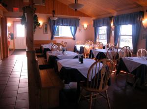 
a dining room with tables and chairs and a large window at Waterview B&B in Pictou
