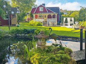 a house with a bird bath in front of a pond at 4 star holiday home in TJÖRN in Almösund
